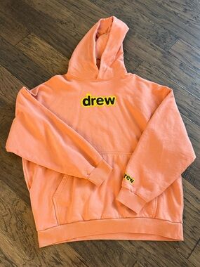 drew house peach hoodie with yellow-black logo